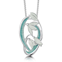 This Snowdrop pendant features four delicate snowdrops framed by curving leaves and stems. The sterling silver piece is hand-enamelled in 'Leaf' enamel.