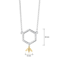 This sterling silver Honeycomb necklace features a small textured hexagon suspended between a silver chain. A small honeybee in 9ct yellow gold hangs from the hexagon.