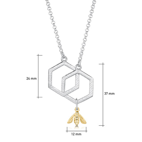 This small sterling silver Honeycomb necklace features two interlinked, textured hexagons suspended between a silver chain. A small 9ct yellow gold honeybee hangs from the bottom of one hexagon. 