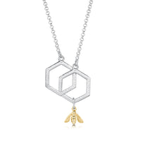 This small sterling silver Honeycomb necklace features two interlinked, textured hexagons suspended between a silver chain. A small 9ct yellow gold honeybee hangs from the bottom of one hexagon. 