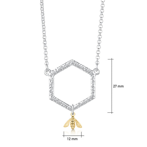 This sterling silver Honeycomb necklace features a small textured hexagon suspended between a silver chain. A small honeybee in 9ct yellow gold hangs from the hexagon.