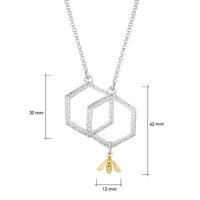 This medium sterling silver Honeycomb necklace features two interlinked, textured hexagons suspended between a silver chain. A small 9ct yellow gold honeybee hangs from the bottom of one hexagon. 