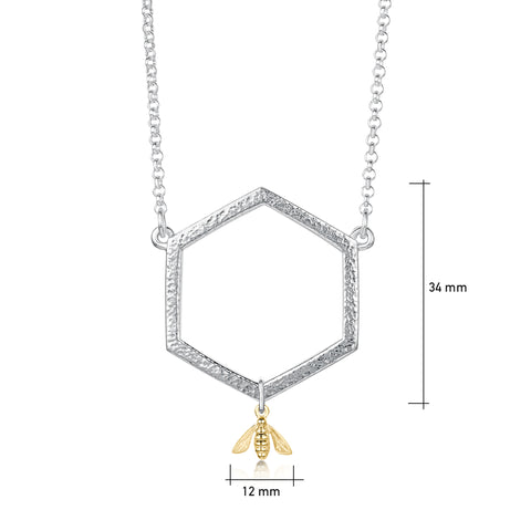 This sterling silver Honeycomb dress necklace features a small textured hexagon suspended between a silver chain. A small honeybee in 9ct yellow gold hangs from the hexagon.